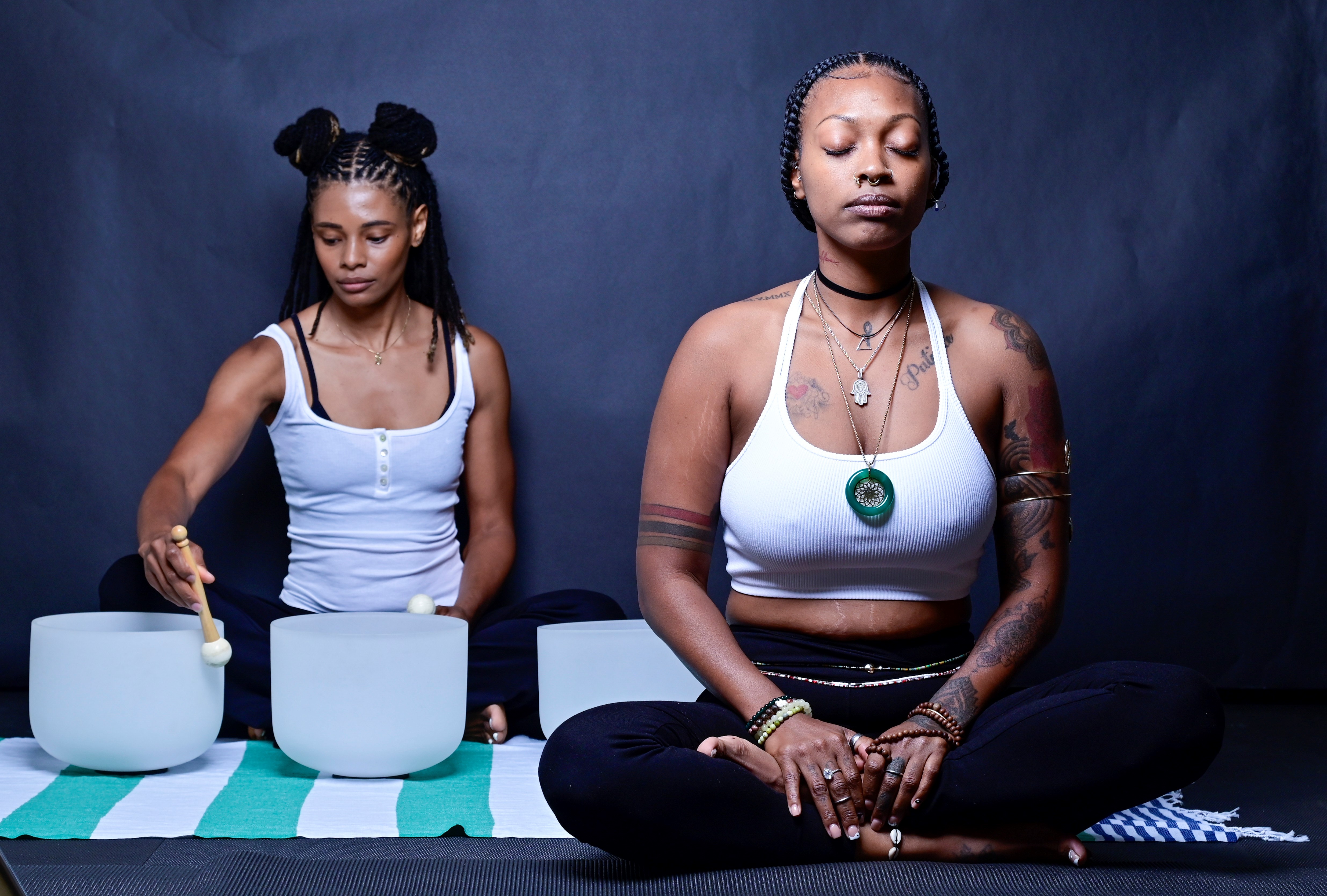 The Village PT and Wellness leading a meditation group with sound bowls.