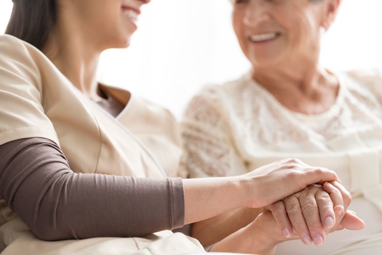hospice nurse helping patient
