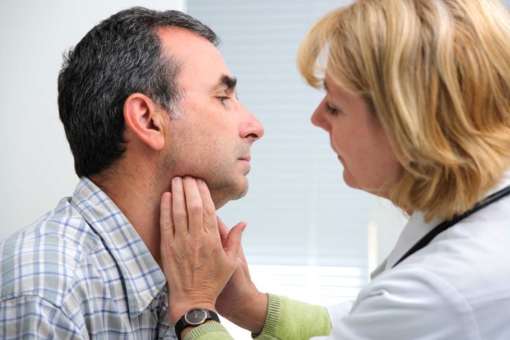 doctor examining neck cancer patient