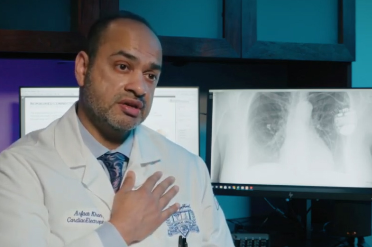 Dr Arfaat Khan with his hand on his heart