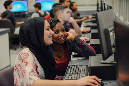 Two students working on the computer together