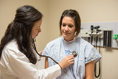 resident examing patient