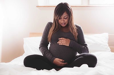 pregnant woman with hands on belly