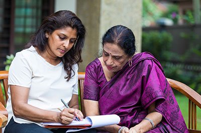 Mother and daughter filling in paperwork