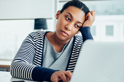 tired woman at computer