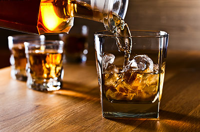 someone pouring whiskey