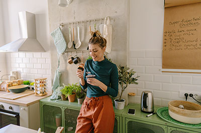 person standing and eating in kitchen