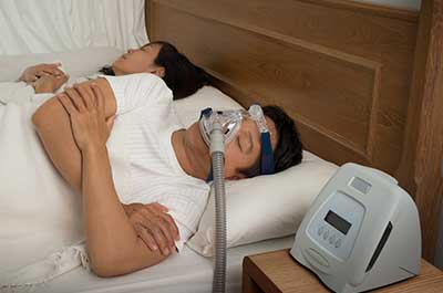 man sleeping with cpap machine
