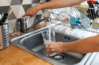person drinking tap water