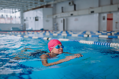 older woman swimming inside