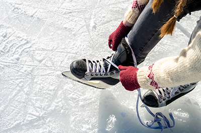 woman putting on ice skates