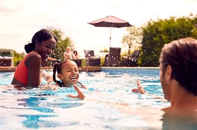 family swimming in pool