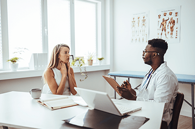 young woman talking to doctor