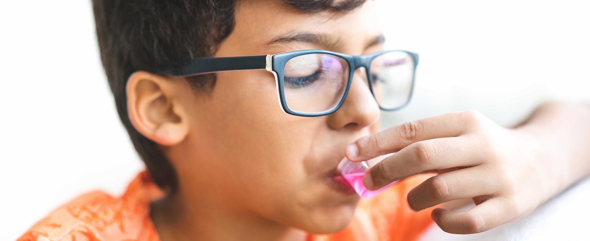 boy taking medicine