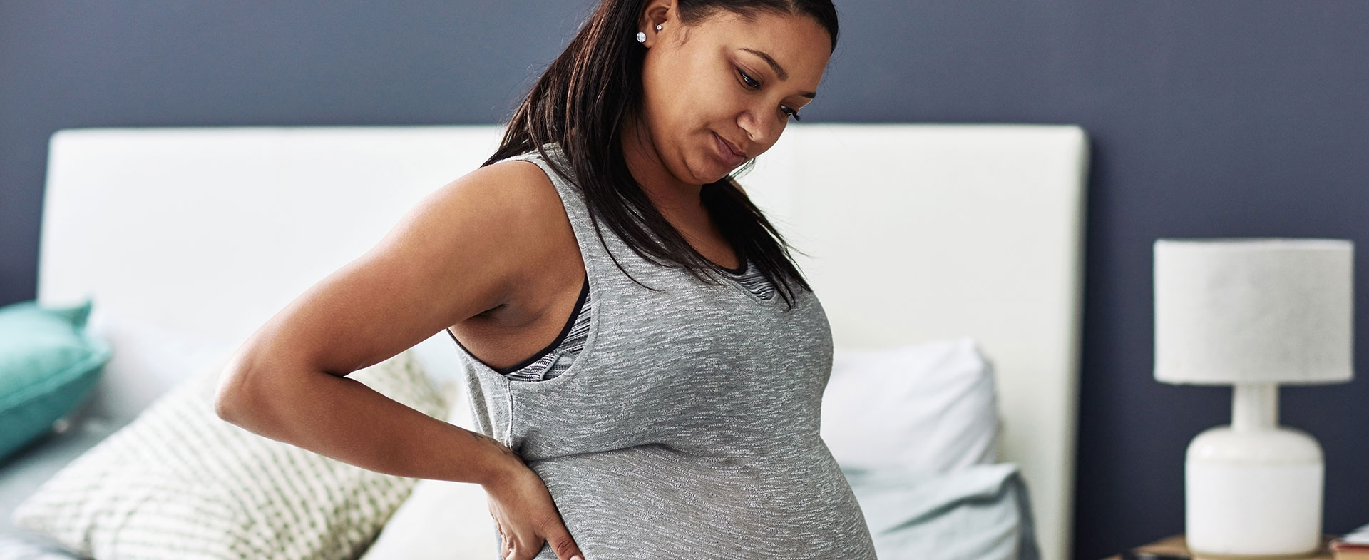 pregnant woman sitting on bed