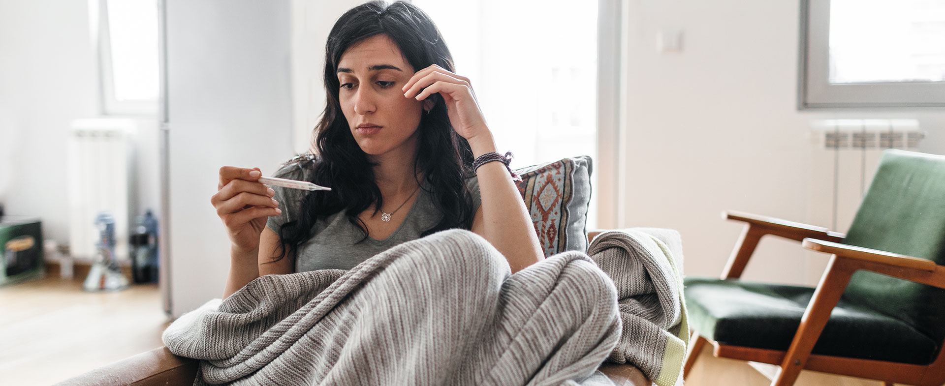 woman checking thermometer