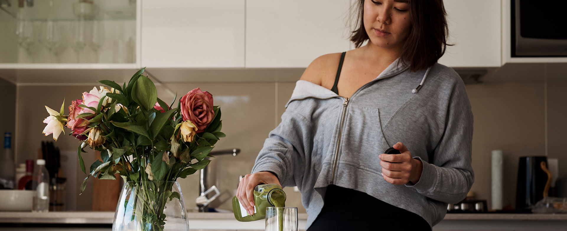 woman pouring green juice