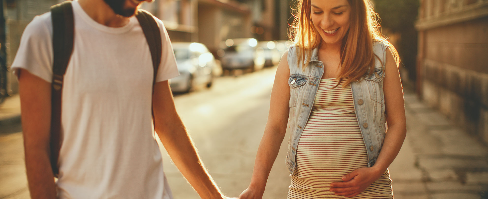 pregnant couple walking outside
