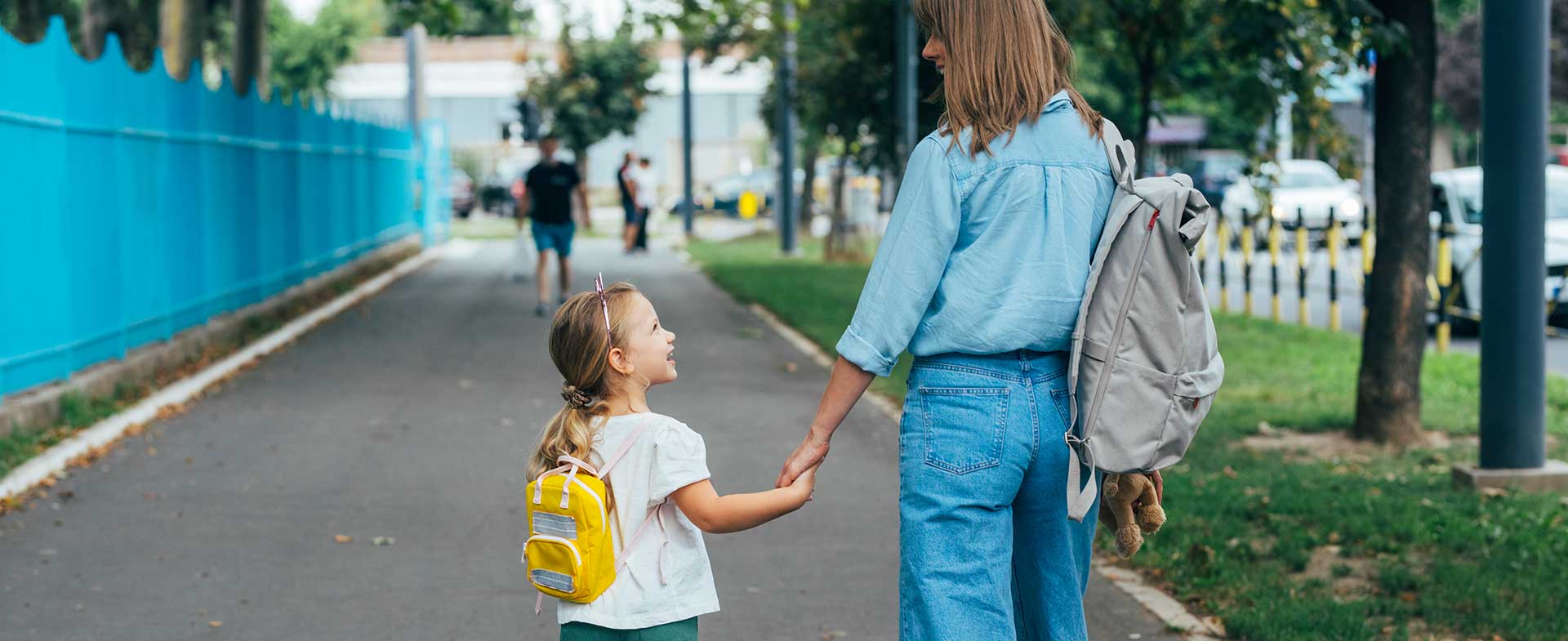 Mom walking daughter to school