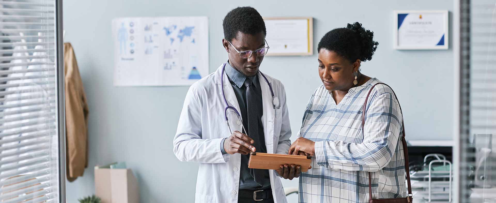 A doctor reviewing patient information with the patient in the office