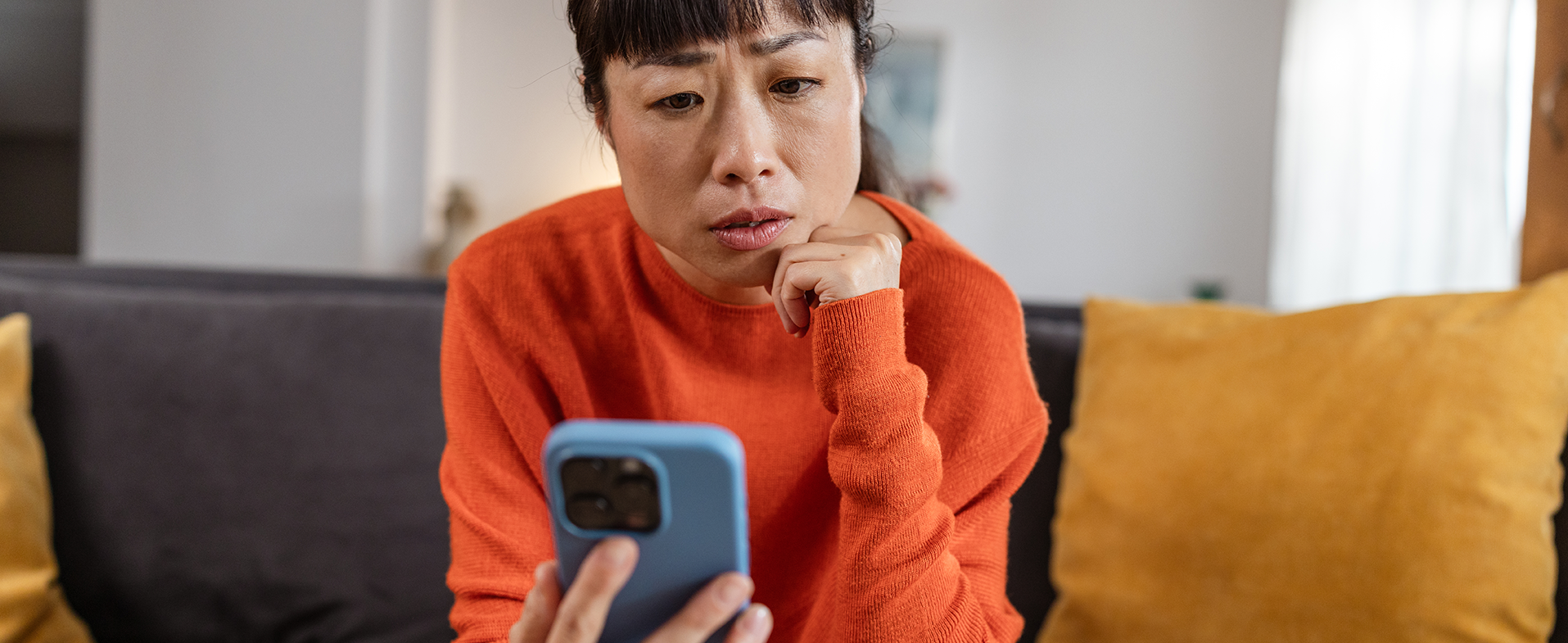 worried woman looking at phone