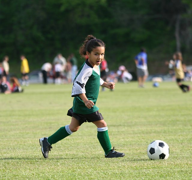 little girl playing soccer