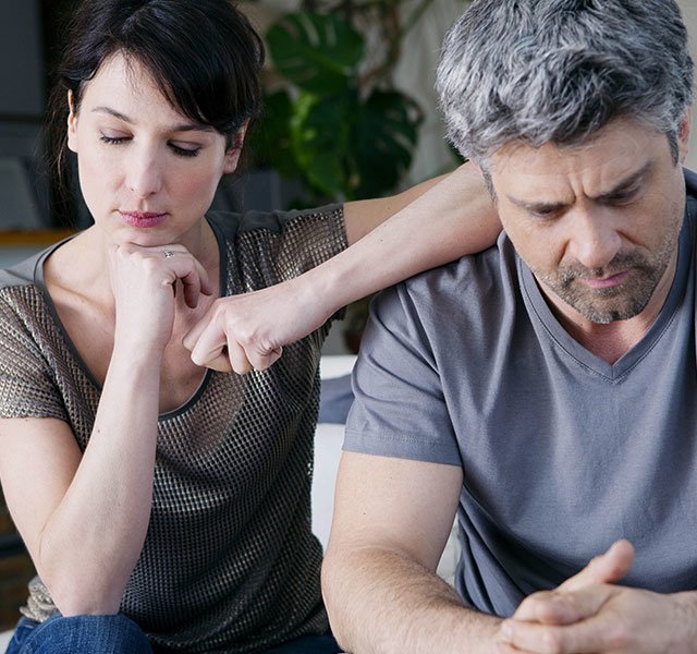 concerned looking couple