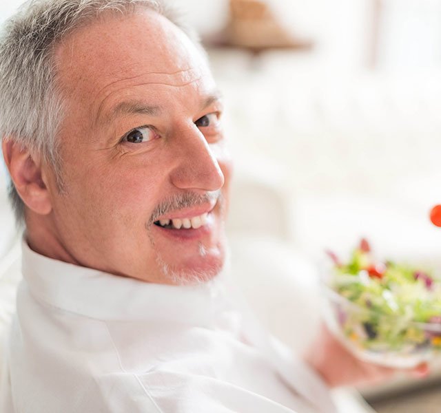 man eating a salad