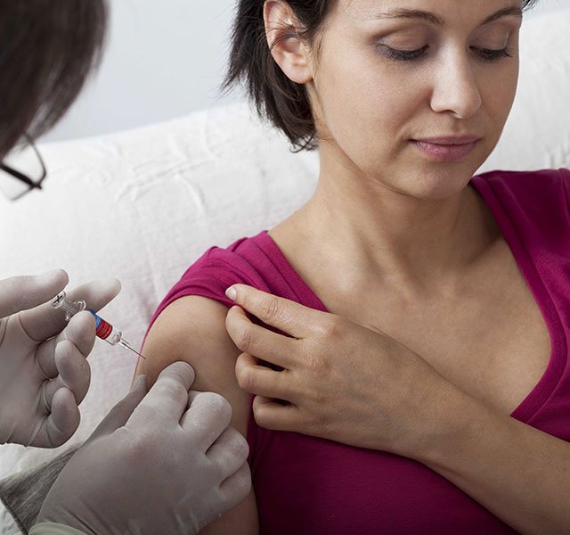 woman getting a vaccine in her arm