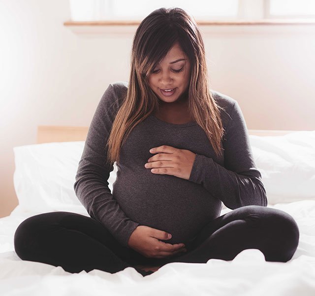 pregnant woman with hands on belly