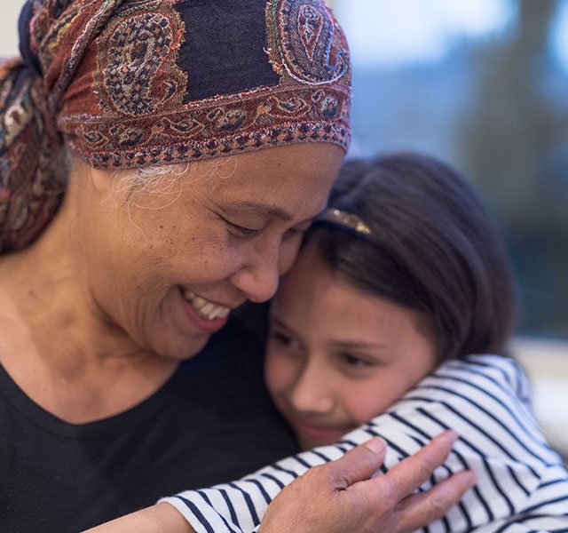 older woman cuddling child