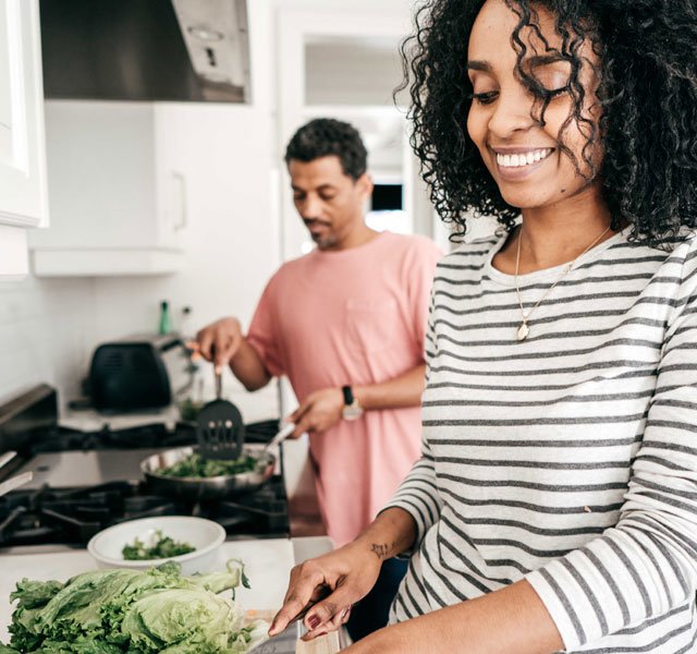 couple cooking vegetables
