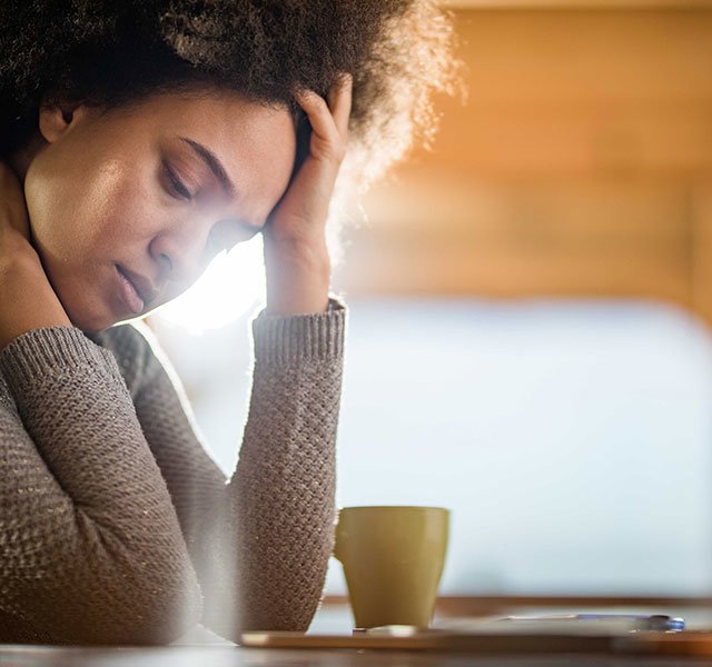 sad woman looking at laptop