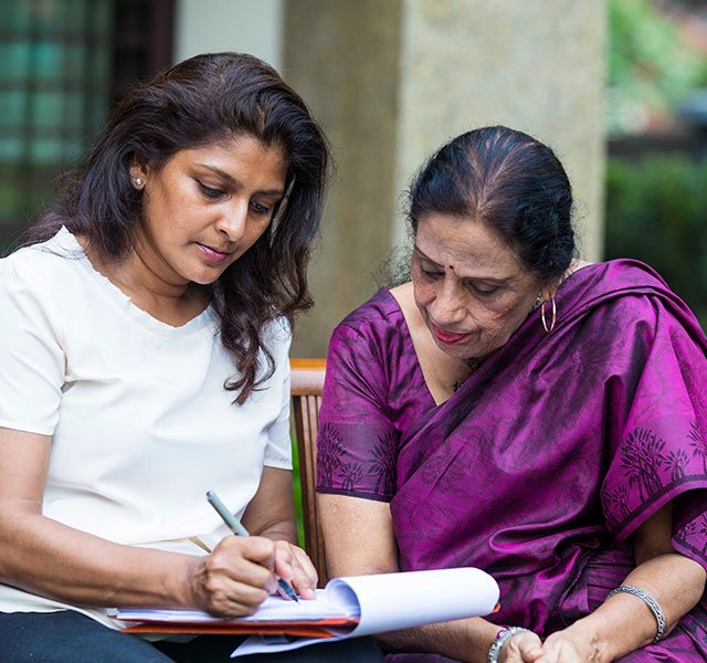 Mother and daughter filling in paperwork