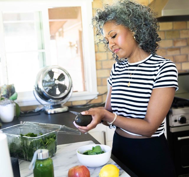 older woman making salad