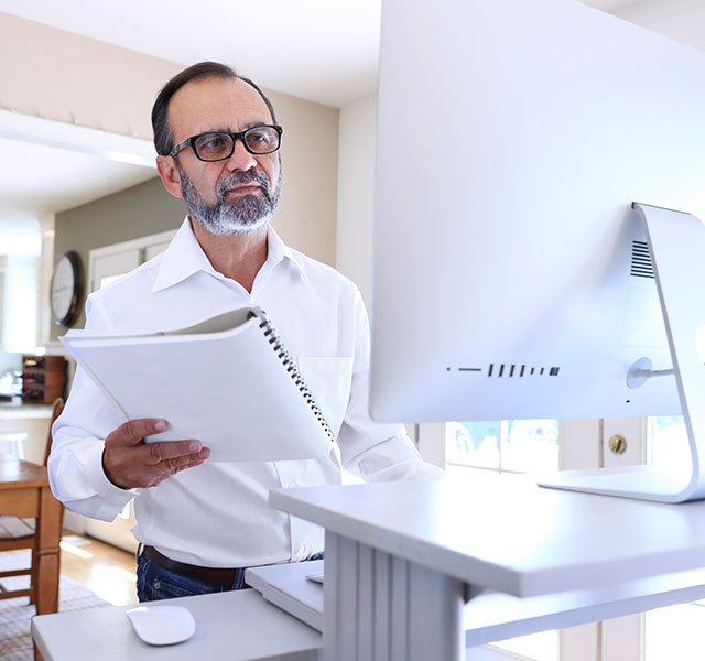 man working at standing desk
