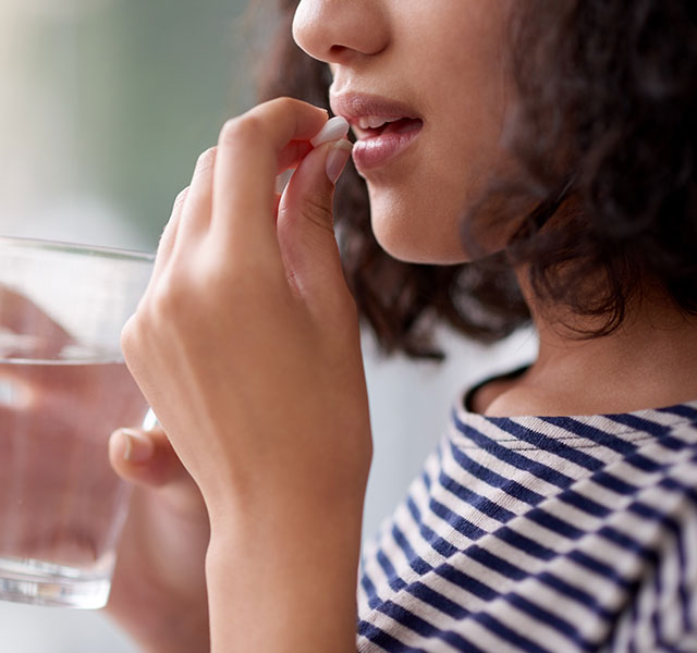 woman taking supplement