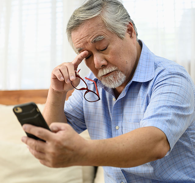 man trying to read phone