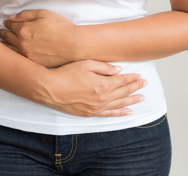 woman holding stomach