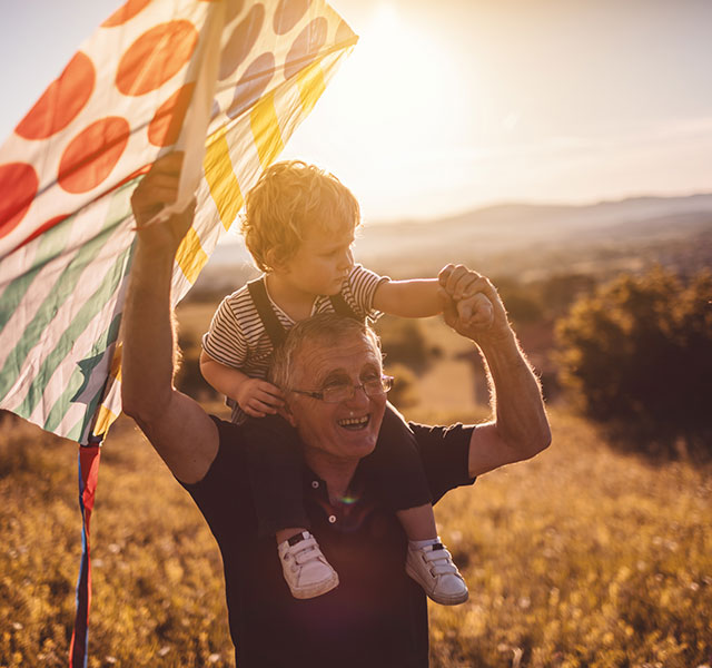 grandfather and grandson flying kite