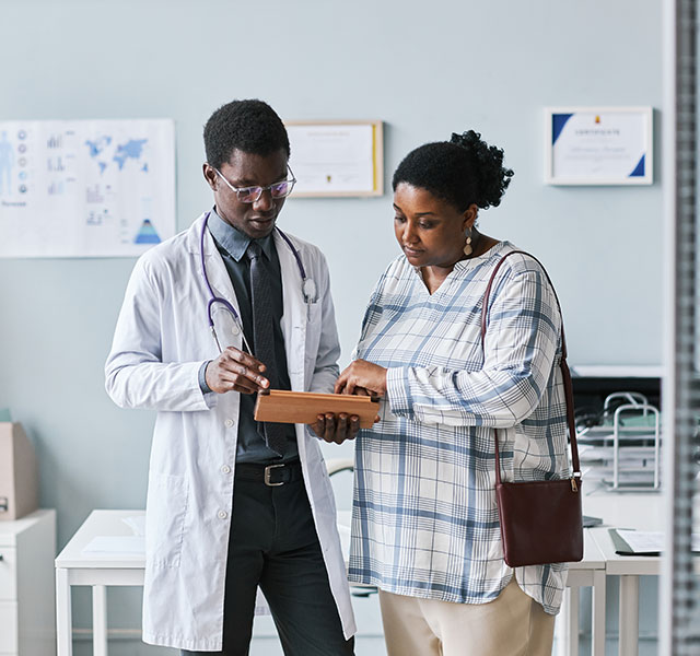 A doctor reviewing patient information with the patient in the office