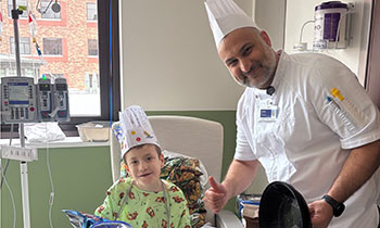 Patient at St. John Children’s Hospital poses for photo with hospital chef.