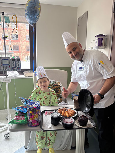 Patient at St. John Children’s Hospital poses for photo with hospital chef.