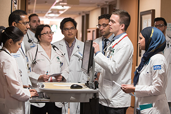 resident discussion around a computer