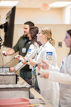 Resident Kate practicing skills in SIM center