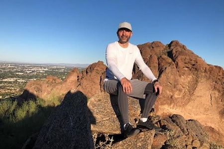 colorectal cancer patient james posed on a mountain