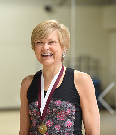 Photo of woman wearing a 50-year survival medal given to her by Henry Ford Health for her accomplishment of living with type 1 diabetes for 50 years.