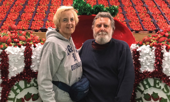 Patient Bob with his wife posing at a strawberry farm