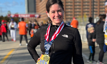 Cardiac rehab patient Nancy smiles with marathon medal