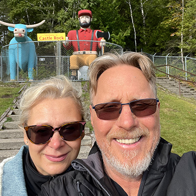 Mike and his wife taking a selfie in front of Paul Bunyan monument 